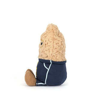 Side view of a Small peanut plush toy with a beige head and navy outfit on a white background