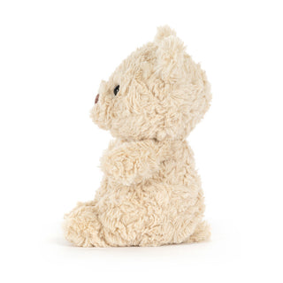 Side view of a Fluffy beige plush teddy bear on a white background