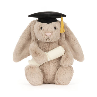 Plush toy bunny wearing a graduation cap and holding a scroll on a white background
