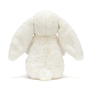 Back of a white plush bunny toy on a white background