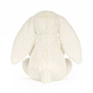 Back of a white plush bunny toy on a white background