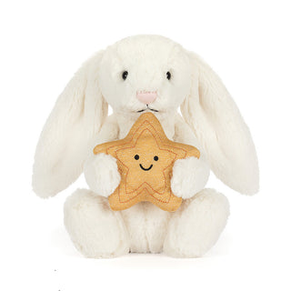 White plush bunny holding a gold star with a smiley face on a white background