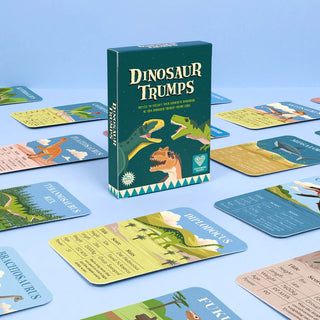 Dinosaur Trumps card game box with cards on a blue background