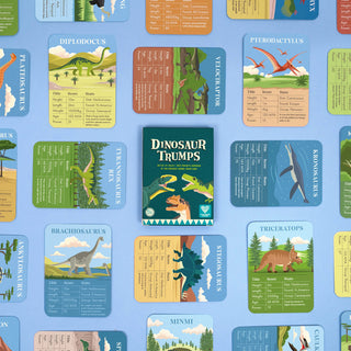 Dinosaur Trumps box surrounded by a variety of included cards