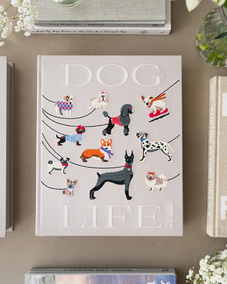 Dogs Life photo album box on a plain table surrounded by books