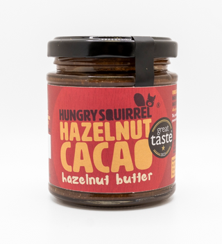 Jar of Hungry Squirrel Hazelnut Cacao nut butter with a red label on a white background
