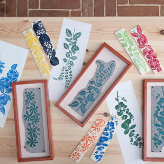 Decorative bookmarks with floral patterns on a wooden surface.