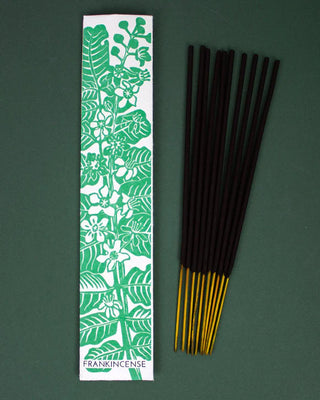 Incense sticks with a Frankincense packaging label on a green background