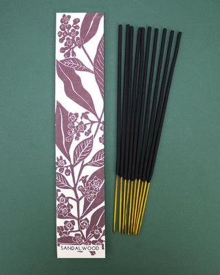 Sandalwood scented Incense sticks with a sandalwood design packaging on a green background
