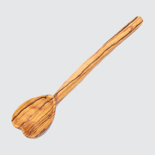 Wooden spoon with a heart shaped spoon head on a gray background