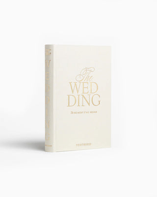 White book titled 'The Wedding' with gold text on a white background