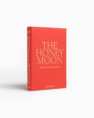 Red book titled 'The Honeymoon' on a white background