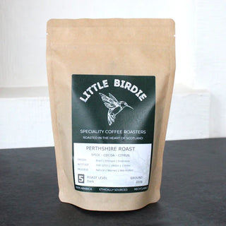Coffee bag from Little Birdie Specialty Coffee Roasters on a dark surface with a white background