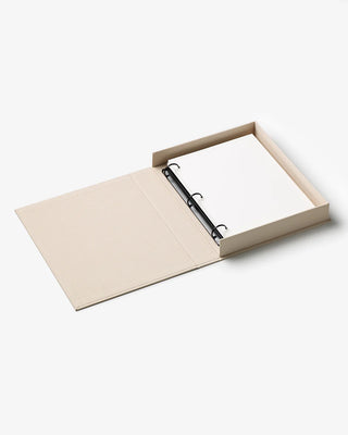 Open beige folder with a black ring binder on a white background
