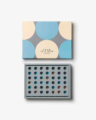 Board game packaging with geometric blue & beige design on a white background with a geometric game board below