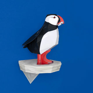 3D paper model of a puffin on a blue background
