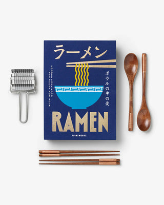 Ramen-themed book with chopsticks, spoon, and fork on a white background