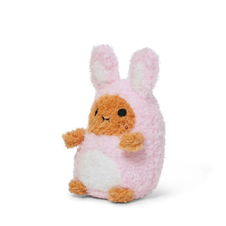 Angled side view of a potato plush toy dressed as a pink bunny against a white background