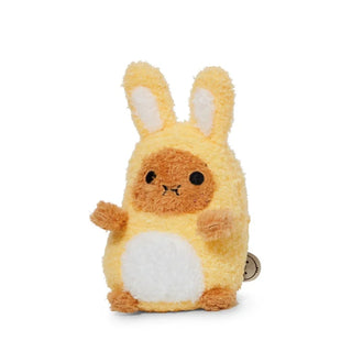 Angled view of a plush potato toy dressed as a yellow bunny on a white background