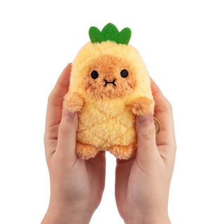 Plush toy shaped like a pineapple held in hands against a white background