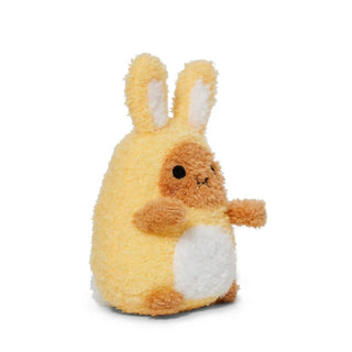 Angled side view of a plush potato toy dressed as a yellow bunny on a white background