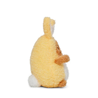 Side view of a plush potato toy dressed as a yellow bunny with white tummy and tail on a white background