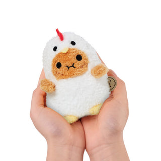 Small plush toy resembling a chicken held in hands against a white background