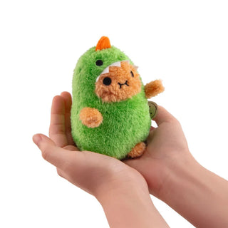 Hands holding a plush potato dressed as a green dinosaur with orange horn
