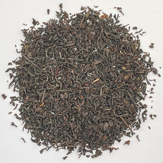 Dry black tea leaves on a white background
