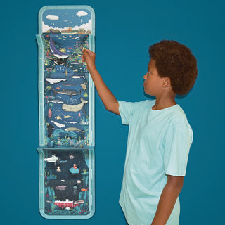 Small child next to the full Seascape wall hanging against a dark blue wall