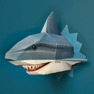 3d paper shark protruding from a teal wall