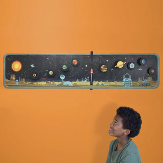 Build your own solar system displayed on an orange wall
