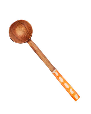 Wooden spoon with an orange handle set against a white background