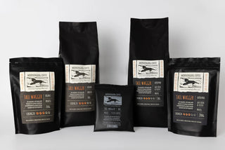 Black coffee bags with labels on a white background