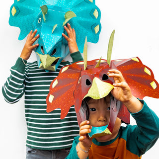 Children wearing a red and blue 3d paper triceratops mask
