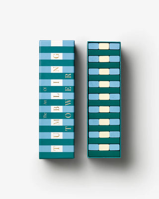 Tumbling Tower game pieces in box with box lid to left. All in Green, white & Blue stripe pattern with gold text on the box