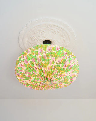 Ceiling light fixture with floral pattern on a white ceiling