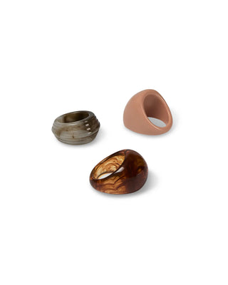 Three rings - tortoiseshell, pebble, and nude coloured - on a white background